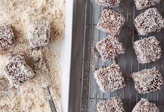 lamingtons<br /><br />Lamingtos are the stuff of an Aussie childhood. Making regular appearances at birthday parties, morning and afternoon teas and community fundraisers across the country, these simply delicious cakes are perfect for whipping up to celebrate Australia Day.<br /><br />For the cake<br />4 eggs<br />200g (1 cup) granulated sugar<br />1 teaspoon vanilla extract<br />200g (1 ⅓ cups) all-purpose (plain) flour<br />1 ½ teaspoons baking powder<br />110g butter, melted and cooled<br /><br />For the icing<br />75g unsalted butter<br />250ml (1 cup) milk<br />65g (1/2 cup) cocoa powder<br />435g (3 cups) icing sugar<br /><br />To assemble<br />Around 6 cups desiccated coconut<br /><br />Method for the sponge<br />Preheat the oven to 350˚F/180˚C/gas 4. Grease and flour a 20cm x 30cm pan, lining the base of the pan with parchment paper. Beat the eggs, sugar and vanilla in a large bowl with an hand mixer (medium-high speed) until pale and thick (around 3 minutes). Sift the flour and baking powder over the egg and sugar mixture and use a rubber spatula to gently combine the dry ingredients. Add the melted butter, about ⅓at a time, gently mixing with a rubber spatula until completely combined, then pour the mixture into the prepared pan.<br /><br />Bake for 25 minutes, or until a skewer inserted into the middle of the cake comes out clean. The cake should spring back when lightly touched in the centre. Turn cake onto a wire rack to cool.<br /><br />Cut cake into even, bit-sized pieces about 4-5cm.  You will probably end up discarding the edge pieces, as they won’t be completely square. At this stage you can refrigerate the cake for a few hours or leave the cake overnight in an airtight container, because a slightly less fresh cake will be easier to dip in the chocolate icing.<br /><br />When you are ready to dip the cakes, set up an area large enough to accommodate bowls for the cake pieces, the chocolate icing, the coconut and also a large tray topped with parchment paper and a cooling rack. You will need to work quickly to dip the cakes so having everything organised in advance will help.<br /><br />Method for the icing<br />Sift the icing sugar and the cocoa powder into two different bowls. In a large saucepan, melt the butter, then mix in the milk. Next, using a whisk to stir, start to add the cocoa powder. Once the cocoa powder is completely dissolved, add the icing sugar about a cup at a time, whisking constantly to prevent lumps. When all the icing sugar is combined, pour the chocolate mix into two separate bowls – that way when one mix gets full of crumbs you can switch to the next one.<br /><br />Working quickly, using a fork, dip the cake cubes into the chocolate mix and roll them around with the tines of the fork to completely coat. Drain any excess mixture off the cakes then drop them in the coconut and roll them around lightly to coat evenly with coconut. Set the cake cubes on the cooling rack placed over parchment paper to drain. You can refrigerate the cakes to help set the icing, then bring them to room temperature before serving.