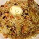 MALABAR CHICKEN BIRYANI<br /><br />Malabar Chicken Biriyani is a non vegetarian rice variety. This delicacy from the Malabar region of Kerala is very popular among Biriyani lovers.<br /><br />Ingredients<br />Basmathi rice - 1 kg<br />Chicken - 1<br />Biriyani Masala Paste<br />(green chilly, cinnamon, cloves, fennel, cardamom, peppercorn) - 4tbsp<br />Green chilly - 10<br />Ginger garlic paste - 2 tbsp<br />Coriander leaves - 50 g<br />Mint leaves - 25 g<br />Curd - 150 ml<br />Tomato - 150 g<br />Onion - 1 kg<br />Black cumin seeds - 1 tsp<br />Cinnamon stick - 2 pieces<br />Bay leaves - 2<br />Cashew nuts kismis - 50 g<br />Cardamom - 5<br />Ghee - 200 g<br />Coriander powder - 2 tbsp<br />Milk - 500 ml<br />Saffron - 1 pinch<br />Water (For rice) - 1 litre<br /><br />Method of preparation<br />Heat the ghee in a saucepan; saute the onions till golden brown colour and add sliced tomatoes saute well. Put ginger garlic paste, curd and biriyani masala and turmeric powder, and coriander powder. Add the chicken pieces and cook well. Soak the rice about 10 minutes and drain well. Melt the ghee in a saucepan and add in the spices and sliced onion mint, coriander leaves, cashew nuts, kismis, bay leaves and saute till brown in colour. Add milk and water. Allow to boil and then add rice. Lower the heat, cover and continue to cook for 15 minutes. Take another saucepan and place half the rice into it. And add the chicken on the top of the rice. And put the remaining rice on top of the chicken. And spread to make an even layer. Make random holes through the rice with a spoon and pour into each a little saffron milk. Place a few knobs of ghee, fried onion, cashew nuts and kismis on the surface and cover tightly.