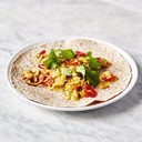 Silky masala eggs<br /><br />Ingredients<br />1 small red onion<br />1 fresh red or green chilli<br />1 clove of garlic<br />½ a bunch of fresh coriander<br />2 large ripe tomatoes<br />4 wholemeal chapatis<br />olive oil<br />½ teaspoon cumin seeds<br />1 teaspoon garam masala<br />½ teaspoon ground turmeric<br />6 large free-range eggs<br /><br />SHARE THIS RECIPE<br /><br />FACEBOOKTWITTEREMAILPINTEREST<br />TAP FOR INGREDIENTS<br />Method<br />Preheat the oven to 160ºC/325ºF/gas 3.<br />On a chopping board, peel and finely slice the onion, deseed and finely slice the chilli, then peel and crush the garlic.<br />Pick and roughly chop the coriander leaves, finely chopping the stalks.<br />Halve, deseed and finely chop the tomatoes.<br />Place the chapatis on a tray and into the oven to warm through.<br />Heat 1 tablespoon of olive oil in a large non-stick frying pan over a medium-low heat, add the onion, chilli, garlic and coriander stalks, then fry for 5 minutes, or until softened, stirring regularly.<br />Add the spices, then cook for 1 minute, or until smelling fantastic.<br />Meanwhile, crack the eggs into a bowl, add a pinch of sea salt and black pepper, then beat with a fork.<br />Scatter the chopped tomatoes into the pan, cook for a further 2 minutes, then pour in the eggs and reduce the heat to low.<br />Stir slowly until you’ve got beautiful silky strips of just cooked egg, surrounded by softer, custardy egg, then remove from the heat – the residual heat of the pan will continue to cook the eggs.<br />Stir the coriander leaves into the eggs, then serve with warm chapatis and a little extra chilli scattered over, if you like.