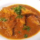 GOAN FISH CURRRY::__::<br /><br />What You'll Need<br />2 pounds (or about 1 kilogram) fish cleaned and cut into pieces (kingfish, monkfish, halibut or tuna)<br />1 1/2 inch lump of tamarind (lump tamarind can be found in Indian food specialty stores)<br />1/2 cup hot water<br />1 large onion sliced<br />1 large tomato sliced<br />7 to 8 dry red chilies<br />2 tablespoons garlic paste<br />1 tablespoon ginger paste<br />1 1/2 cups grated fresh coconut<br />2 tablespoons coriander powder<br />2 tablespoons cumin powder<br />1/2 teaspoon turmeric powder<br />1/2 teaspoon red chili powder<br />2 green chilies slit<br />2 tablespoons vegetable cooking oil<br />Hot water for gravy (approximately 2 cups)<br />Salt to taste<br /><br />How to Make It<br />Soak the tamarind in 1/2 a cup of hot water for 10 minutes. Now mash the tamarind with your fingers to mix it well into the water. Strain through a sieve to extract all the pulp. Keep pulp aside.<br />Put the onion, tomato, coconut, ginger, garlic, dry red chilies, all the spices and the tamar+ind pureé into your food processor and grind well to make a smooth paste (masala).<br />Heat a deep pan on medium flame, then add the oil.<br />Add the green chilies and masala paste you just ground to the oil and fry for 5 minutes.<br />Now add the 2 cups of water (add more water if you would like more gravy) and bring the gravy to a boil. Reduce the flame to a simmer and cook for 10 minutes. Add salt to taste.<br />Gently add the pieces of fish to the gravy and cook for 10 more minutes. Do not cover the pan at any time during the cooking process.<br />Turn off the fire and serve immediately with plain boiled rice.<br />Cooking Tips and Ingredient Storage<br />Fresh spices are the cornerstone of making the best Goan food, or any Indian food for that matter. You may use a coffee grinder as a spice grinder, instead of buying spices that are already ground. By buying spices whole and grinding them as needed, your dishes will have a fuller flavor.